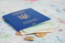 Travel and tourism concept: ukrainian passport and money on a map