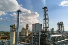 Aerial view of oil and gas refining petrochemical factory with tall refinery plant manufacture structure.