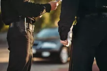 Cops in uniform check the car on road. Law protection, car traffic inspector, safety control job