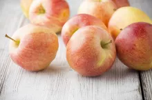 Apple on the wooden background.