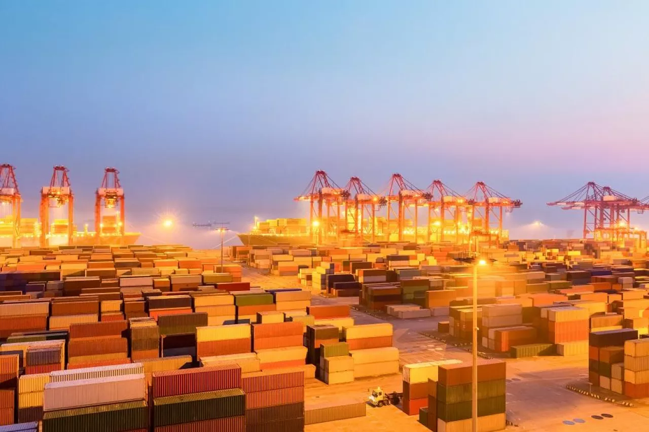 container wharf in nightfall, international import and export trade background