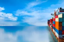 Stern of large cargo ship import export container box on the ocean sea on blue sky back ground concept transportation logistic and service to customer and supply change