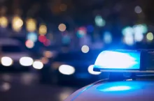 Blue flasher light of siren of police car at night city street. Themes crime, emergency and help.