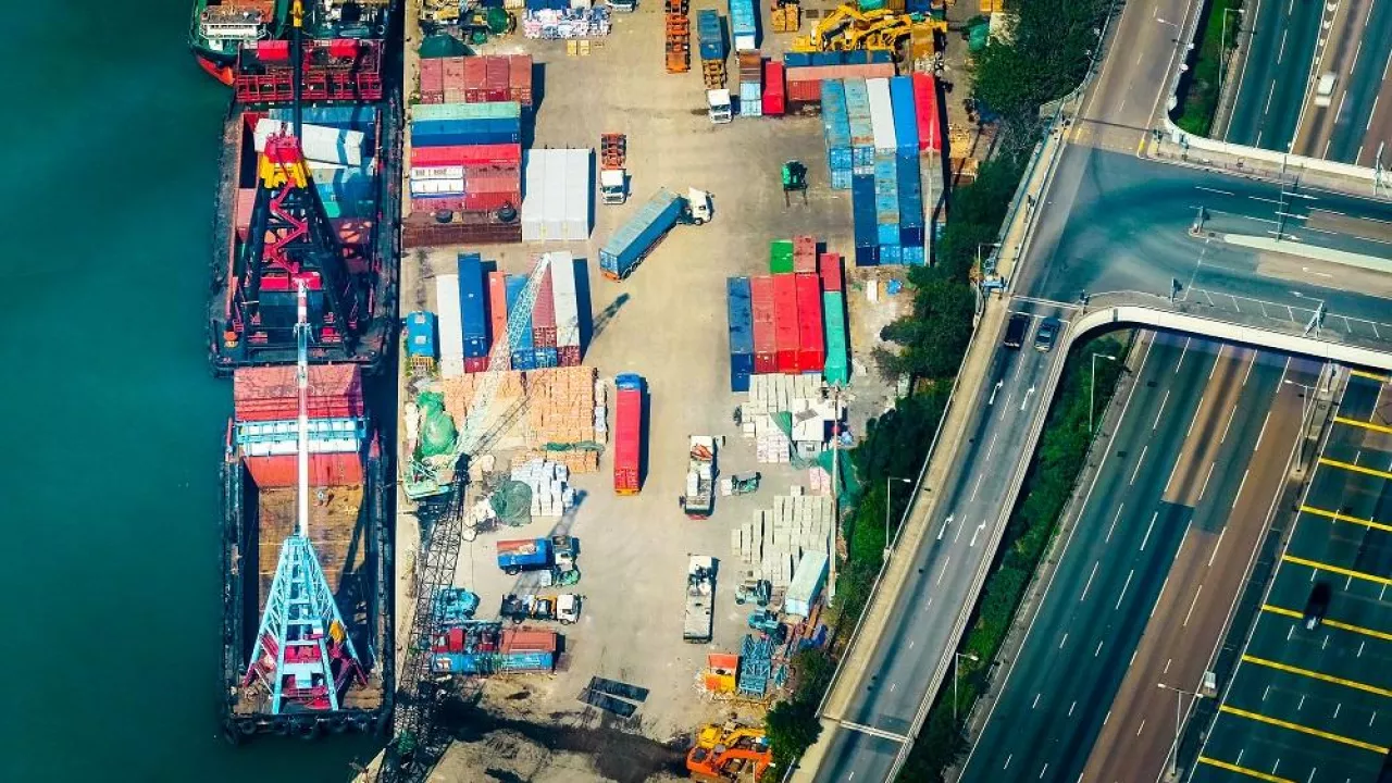 Aerial view cargo ships loaded by crane with cargo containers at a busy port terminal. Hong Kong