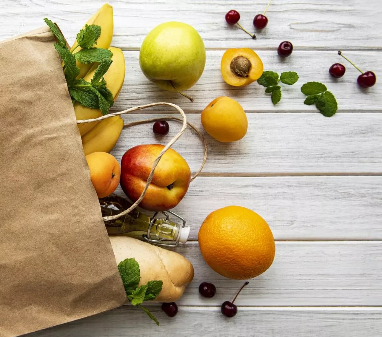 Healthy food background. Healthy food in paper bag, fruits and berries