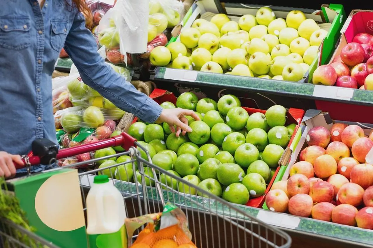 Hand picking apples at a fruit counter