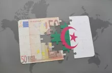 puzzle with the national flag of algeria and euro banknote on a world map background. 3D illustration
