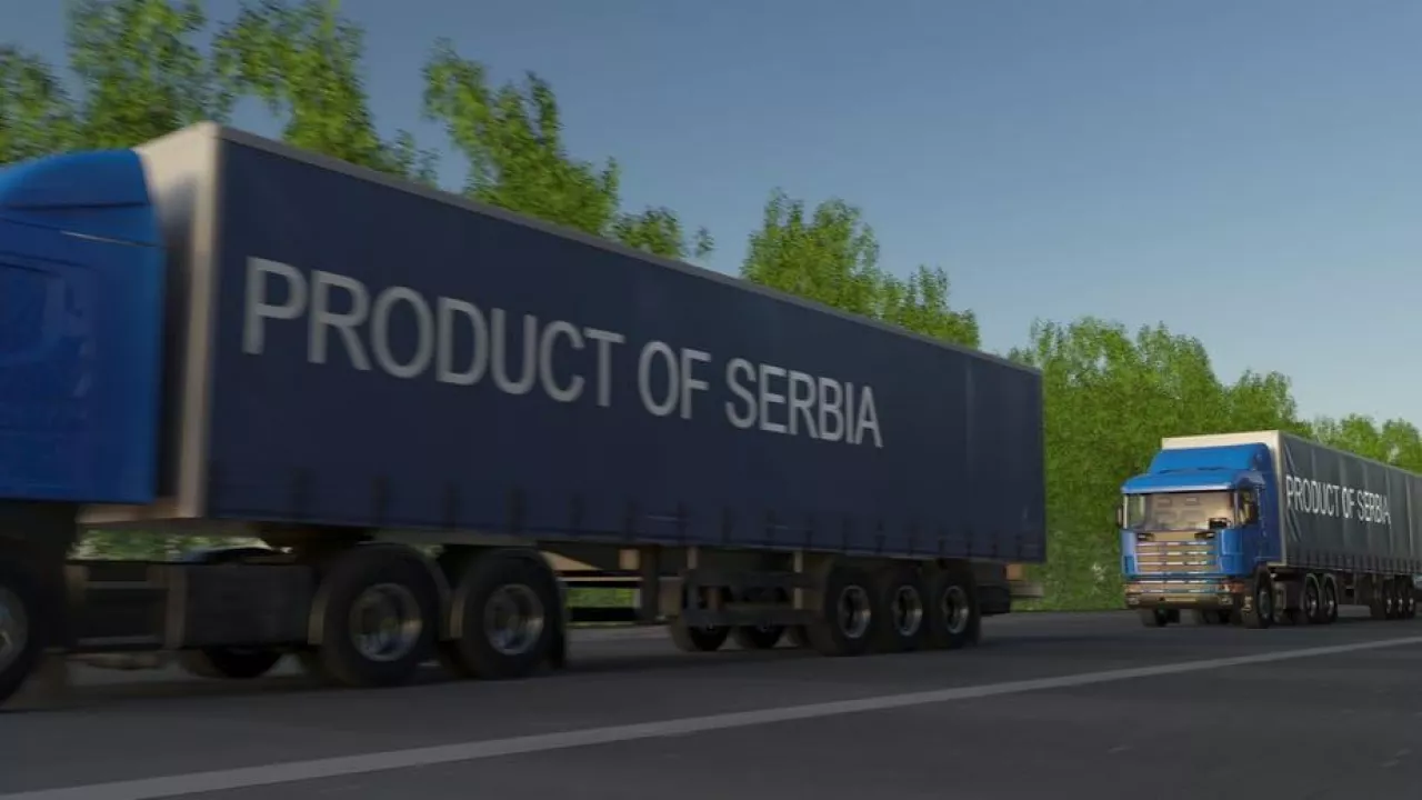 Moving freight semi trucks with PRODUCT OF SERBIA caption on the trailer. Road cargo transportation. 3D